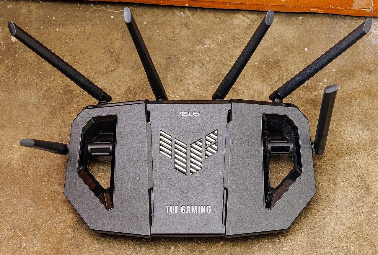 Asus TUF Gaming Wi-Fi router with external antennas on a table