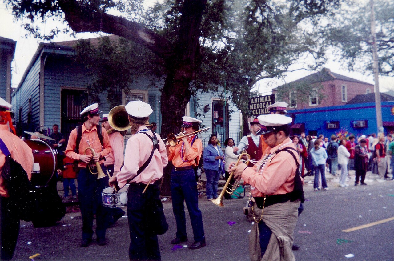 Brass band leading a street parade, illustrative of the marching band that accompanied the AI pause protest