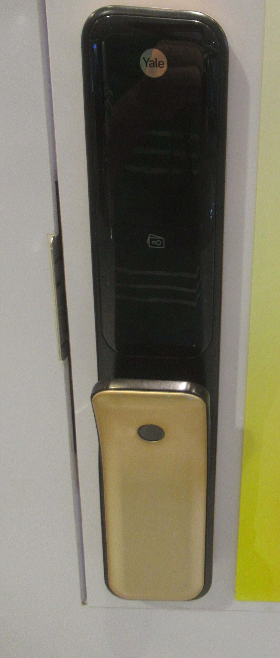 battery free smart lock 2026 -- close-up of a Yale smart lock with facial recognition panel mounted on a door