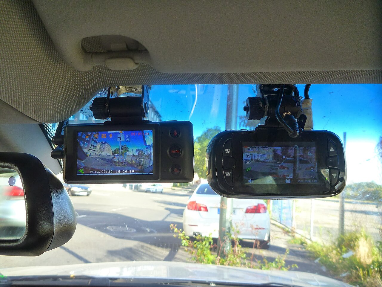 Two dash cams mounted side by side for comparison