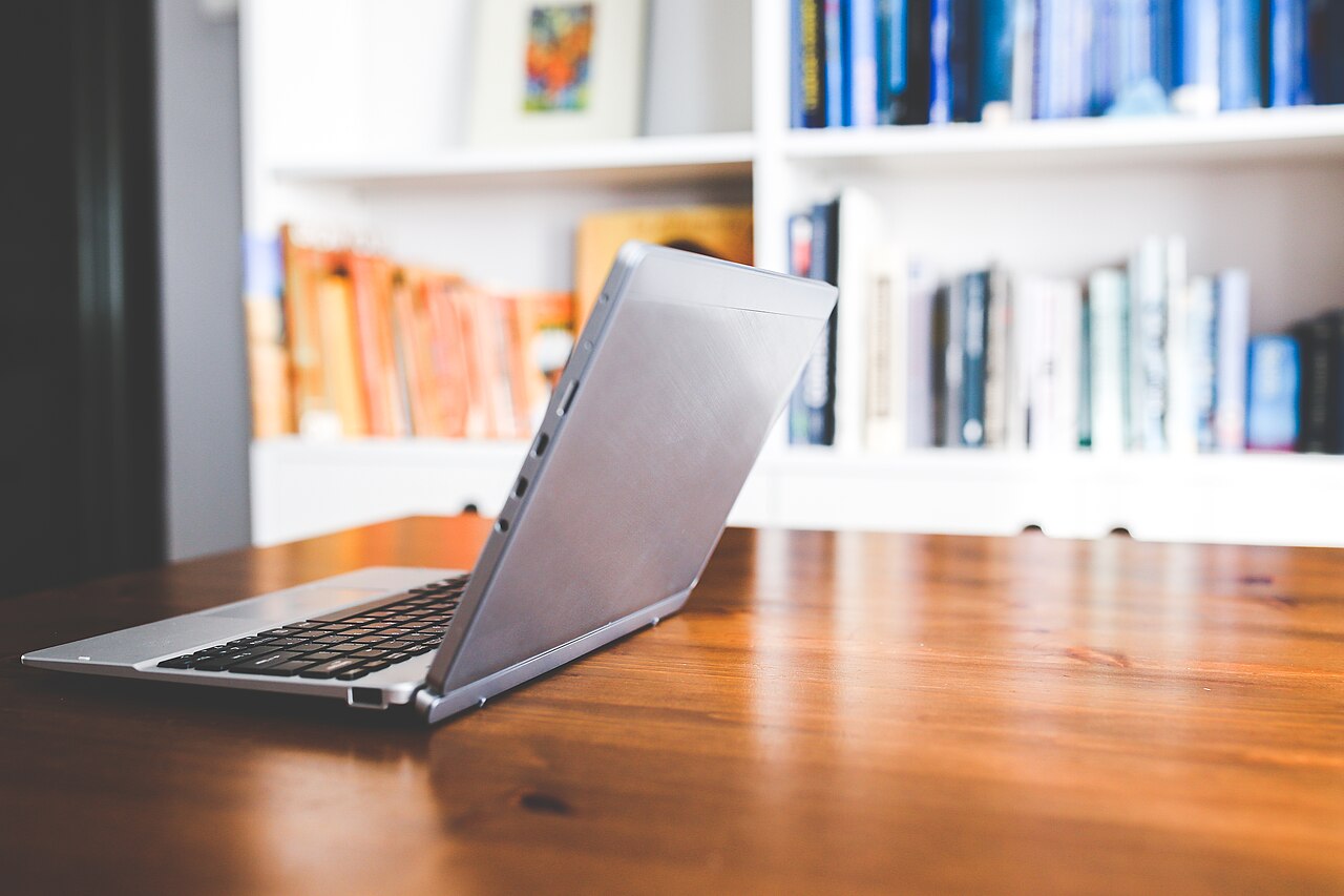 Laptop open on a wooden desk, ready for use