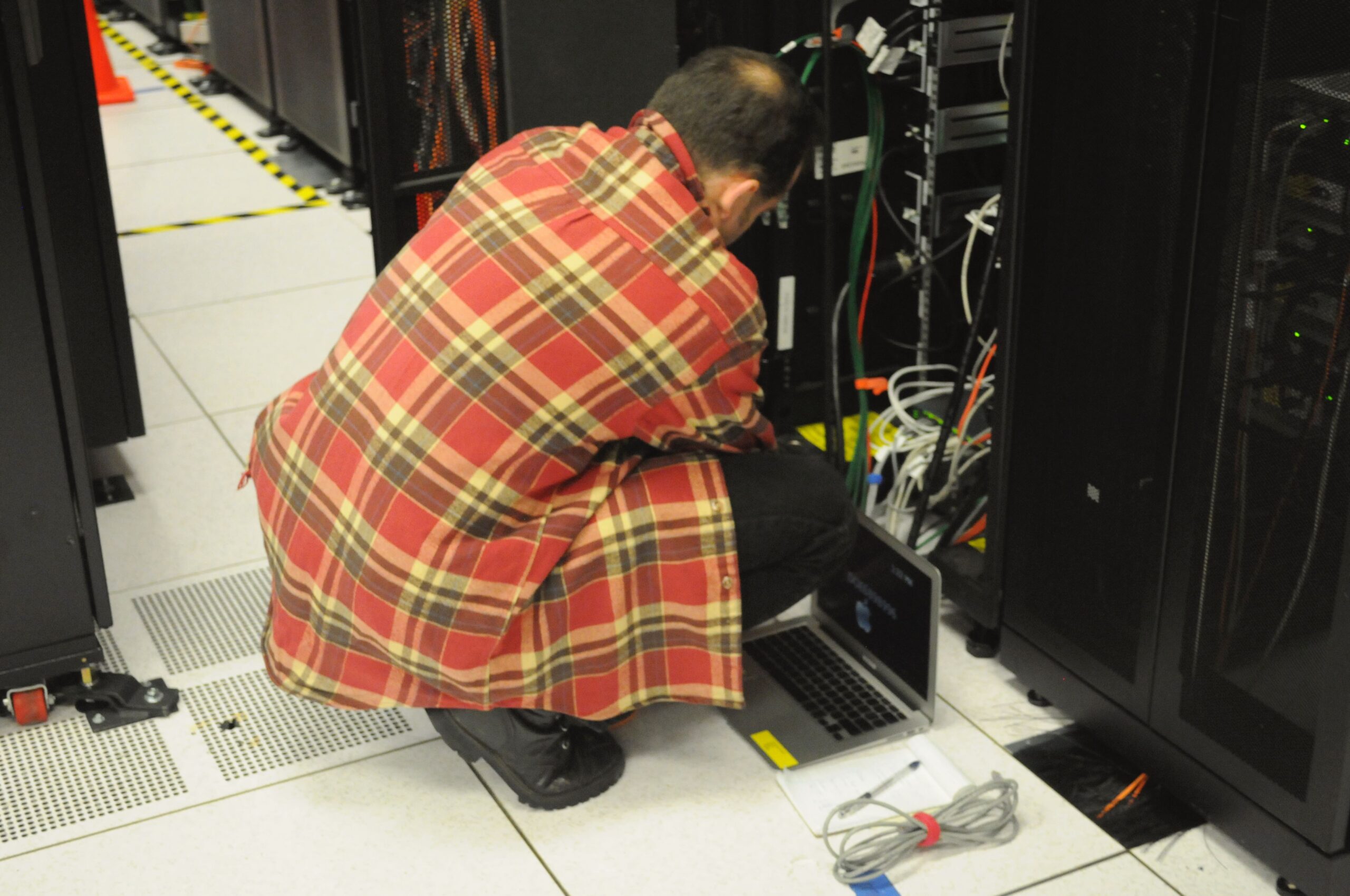 Technician working on a server rack in a data center