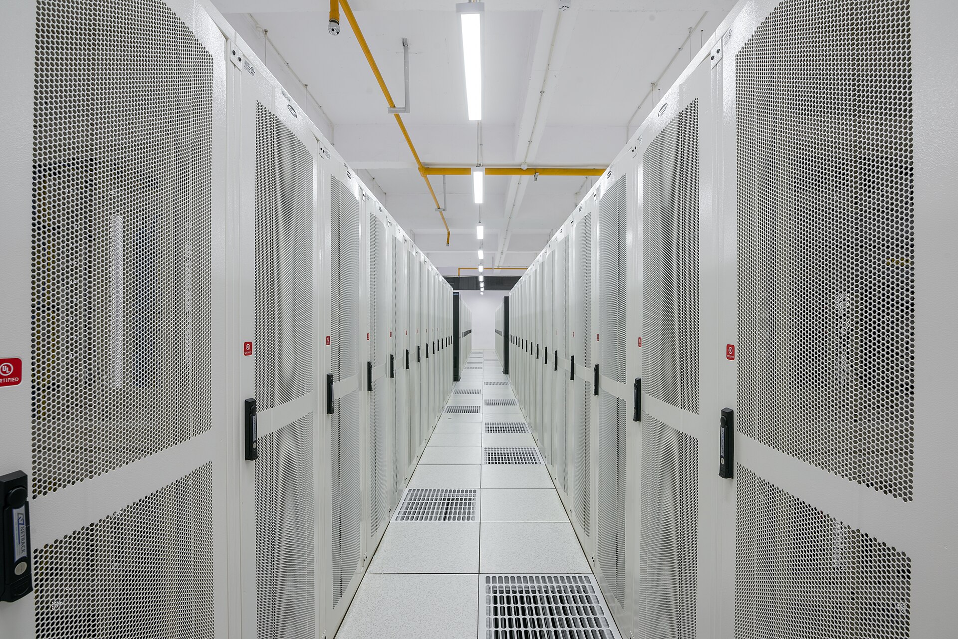 Rows of cloud computing server racks in a modern data center, illustrating AI infrastructure buildout