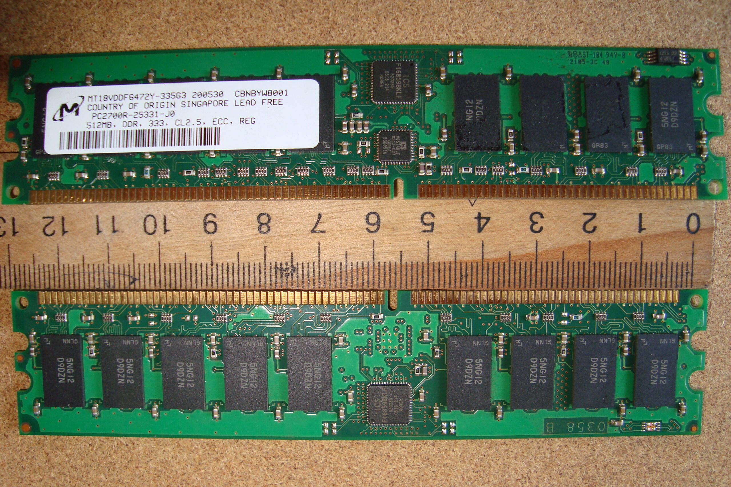 Two Micron PC2700 DDR ECC registered RAM sticks side by side compared with ruler