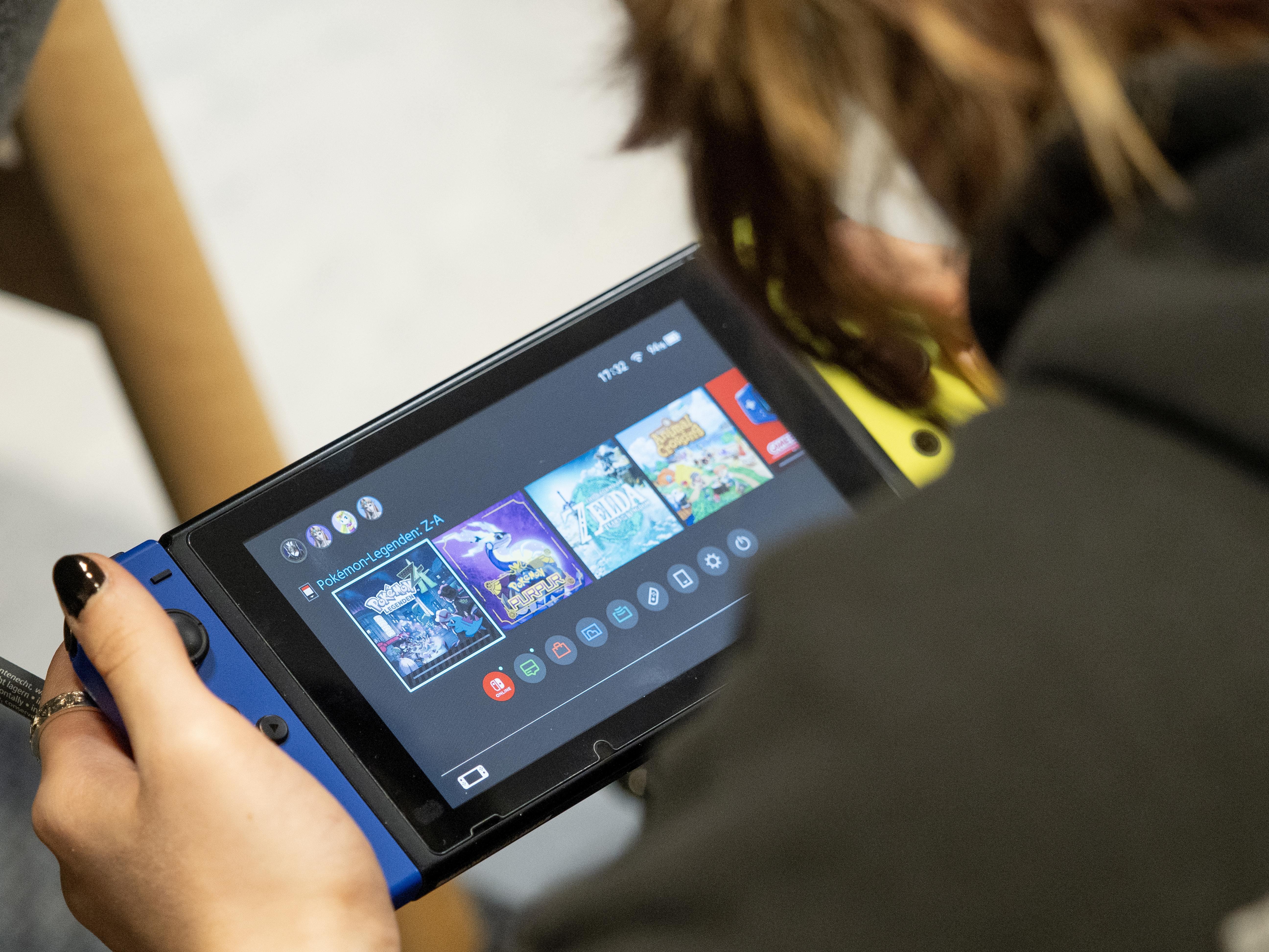Person playing Nintendo Switch in handheld mode
