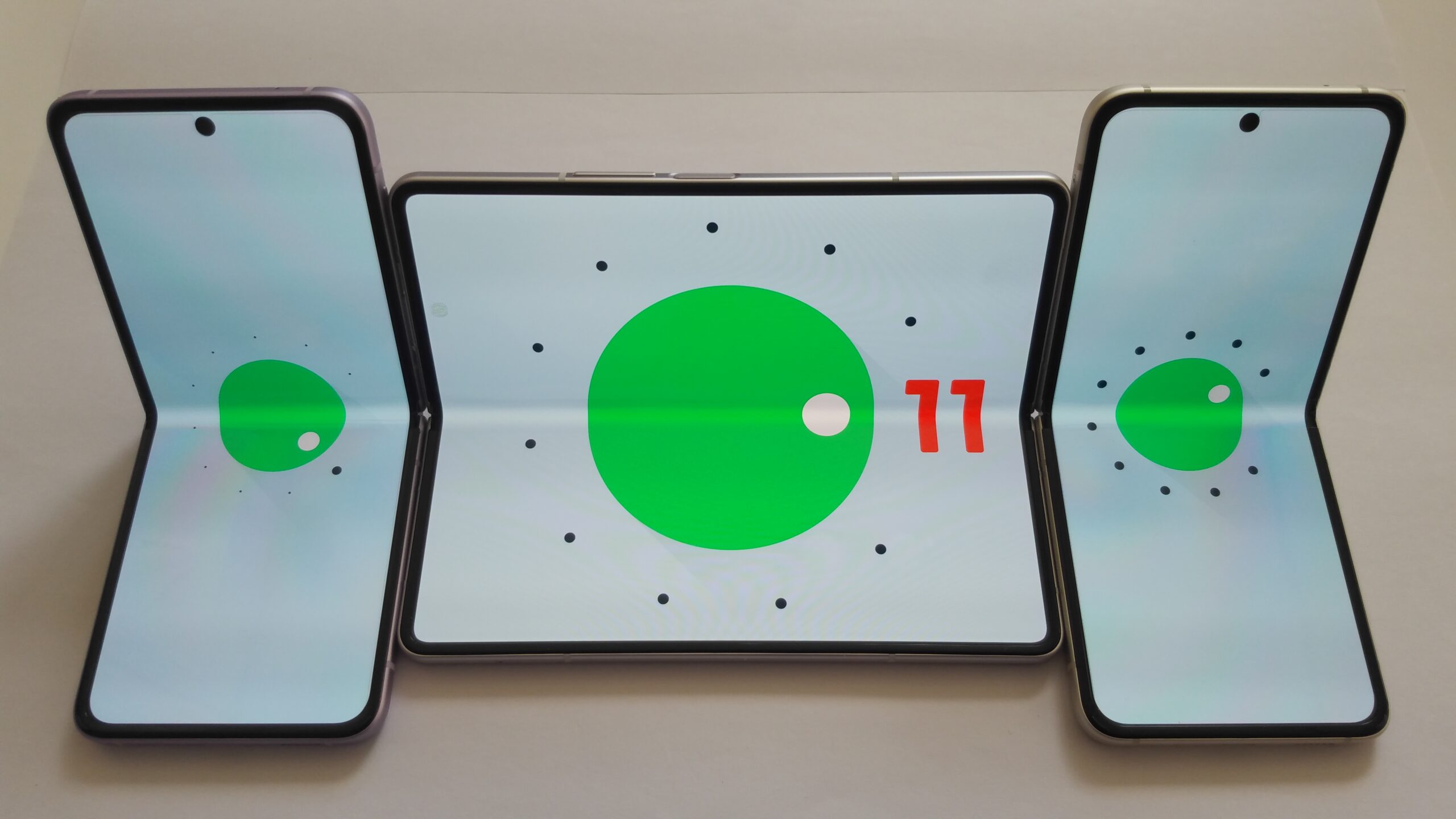 Foldable smartphone fully open showing large inner display with Android 11 interface
