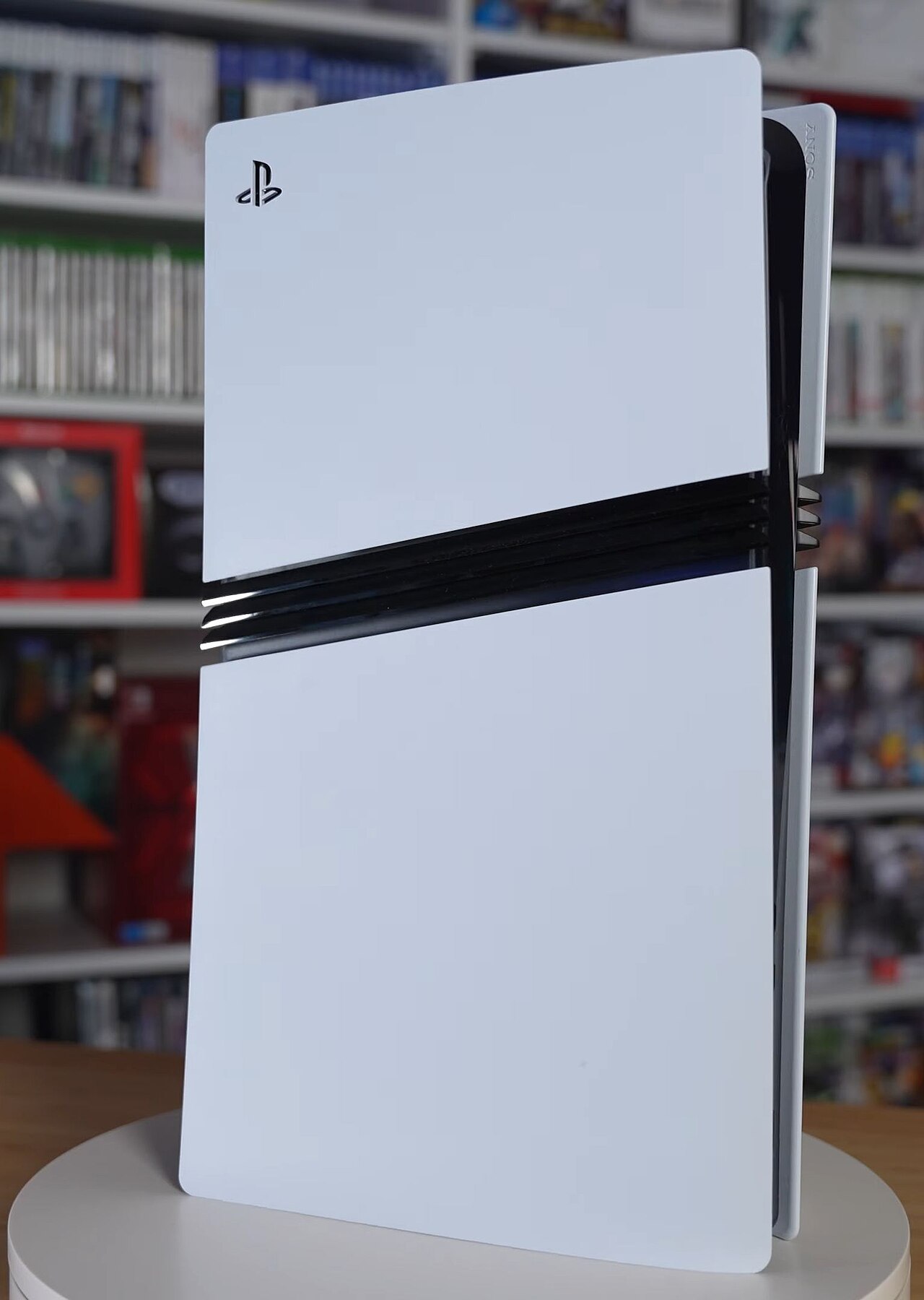 PS6 disc production ending 2028 - PlayStation console beside a shelf of physical game discs