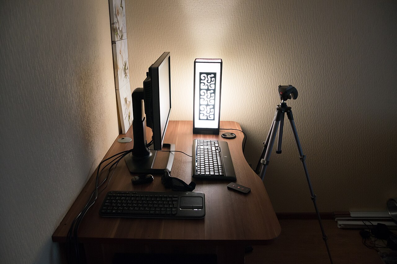 A computer monitor on a desk workstation