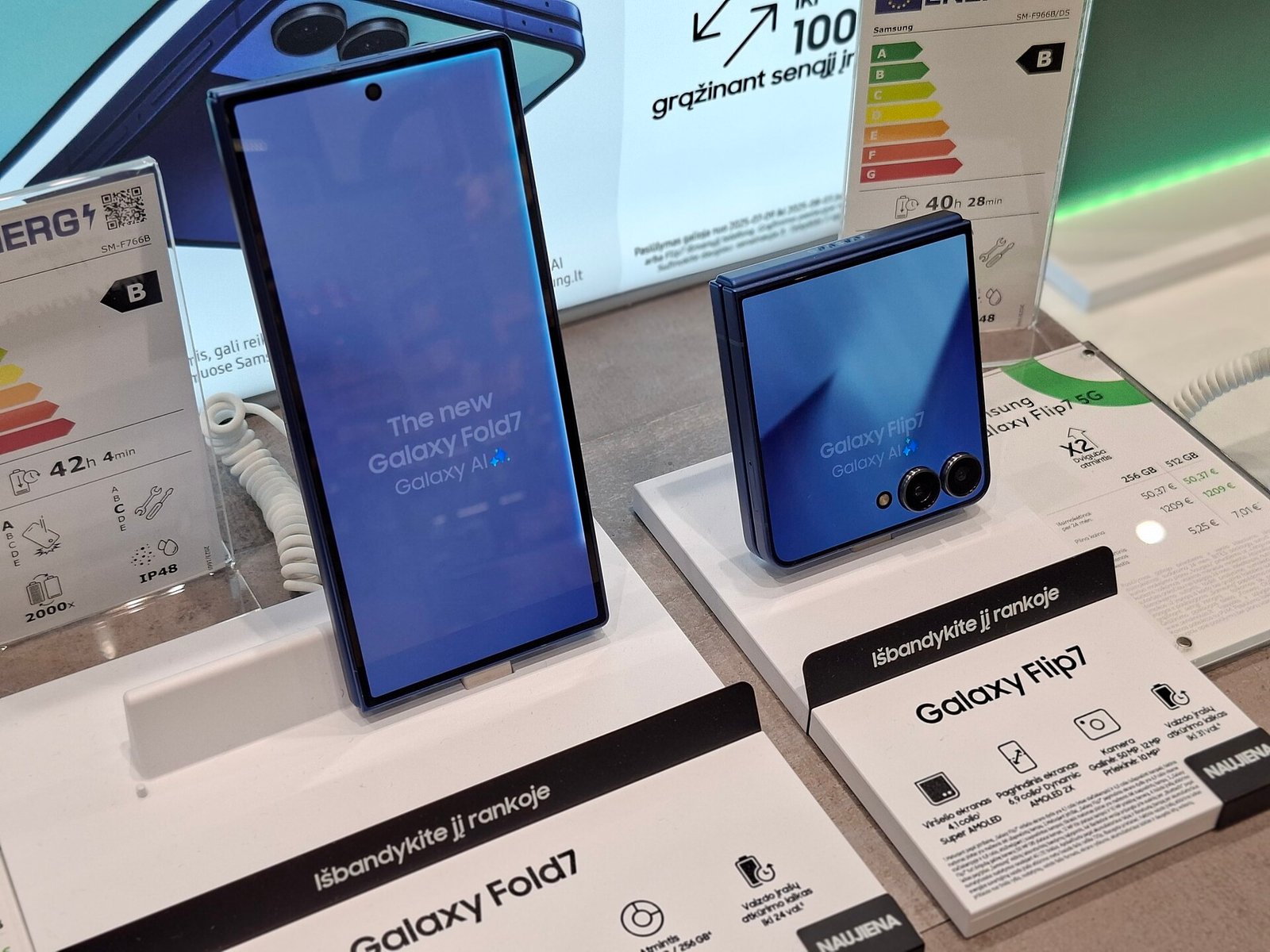 Samsung Galaxy Z Fold7 foldable phone open next to a Galaxy Z Flip7 foldable phone closed, showing its compact clamshell form and hinge
