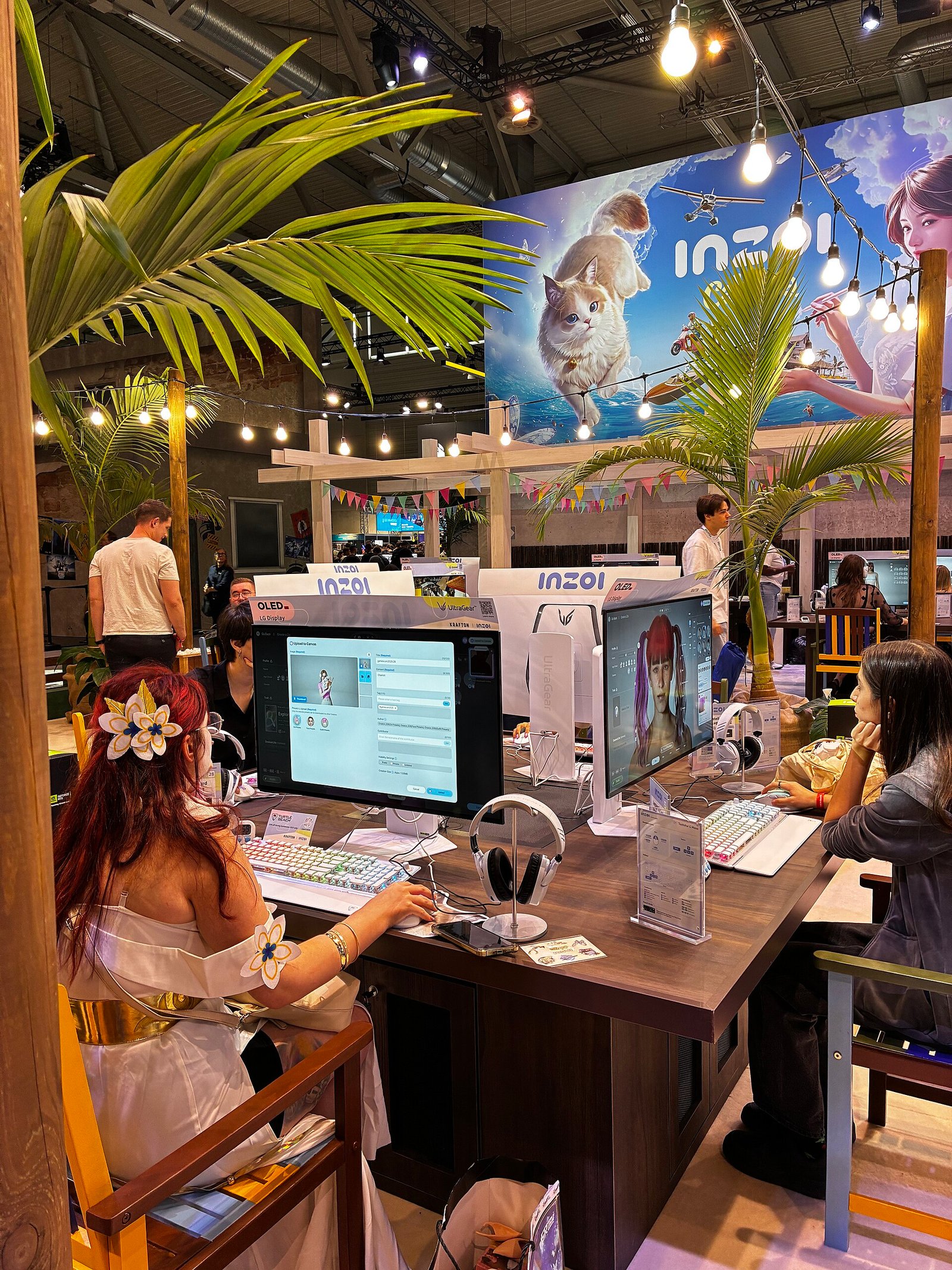 Attendees playing video game demos at gaming stations on the Gamescom 2025 show floor in Cologne