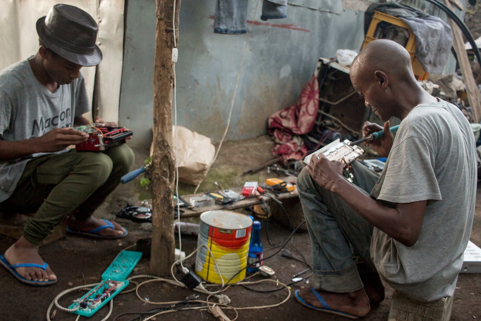 Electronics technician repairing and testing a device on a workbench